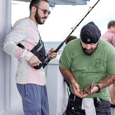 a group of people standing next to a man