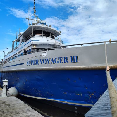 a boat is docked next to a body of water