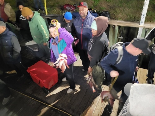 Family Fishing Charters in Myrtle Beach SC People on a dock with fishing gear and caught fish.